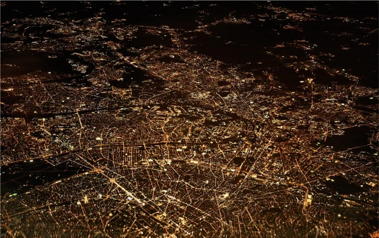 Lumières de la ville visibles depuis l'espace, illuminant la nuit avec des motifs géographiques distincts.