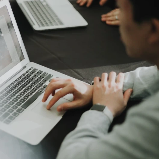 Une personne en train de taper sur un ordinateur portable.